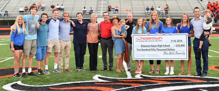Members Of The Gill Family Are Pictured With Student Athletes From Delaware Hayes High School During The Check Presentation